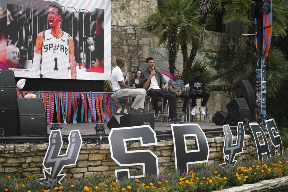 San Antonio Spurs NBA basketball first round draft pick Victor Wembanyama is interviewed by former Spurs player Sean Elliott, left, during a meet the rookies event in San Antonio, Saturday, June 24, 2023. (AP Photo/Eric Gay)