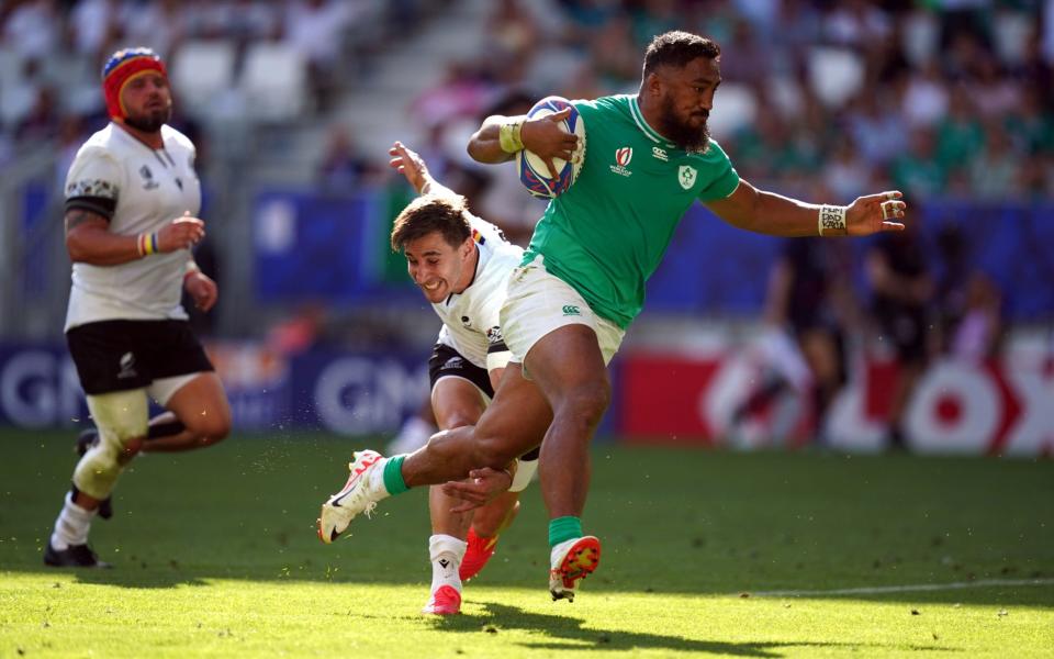 Bundee Aki (right) skips round the fullback to score