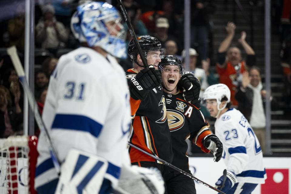 Anaheim Ducks left wing Ross Johnston, second from left, celebrates his goal with right wing Jakob Silfverberg (33) during the first period of an NHL hockey game against the Tampa Bay Lightning, Sunday, March 24, 2024, in Anaheim, Calif. (AP Photo/Kyusung Gong)