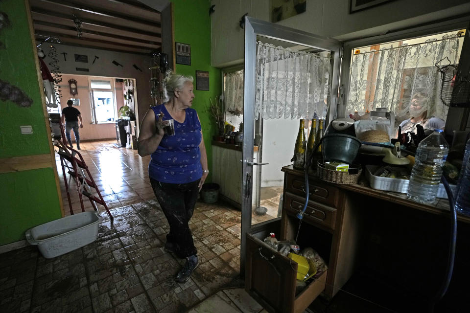A woman, who did not wish to be identified by name, stands inside of her damaged house after flooding in Pepinster, Belgium, Saturday, July 17, 2021. Residents in several provinces were cleaning up after severe flooding in Germany and Belgium turned streams and streets into raging torrents that swept away cars and caused houses to collapse. (AP Photo/Virginia Mayo)
