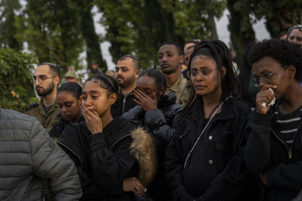 Family and friends of Israeli soldier Staff Sergeant Emanuel Feleke attend his funeral at the Kiryat Gat's military cemetery, Israel, Thursday, Dec. 7, 2023. Feleke was killed during a military ground operation in the Gaza Strip. (AP Photo/Ohad Zwigenberg)