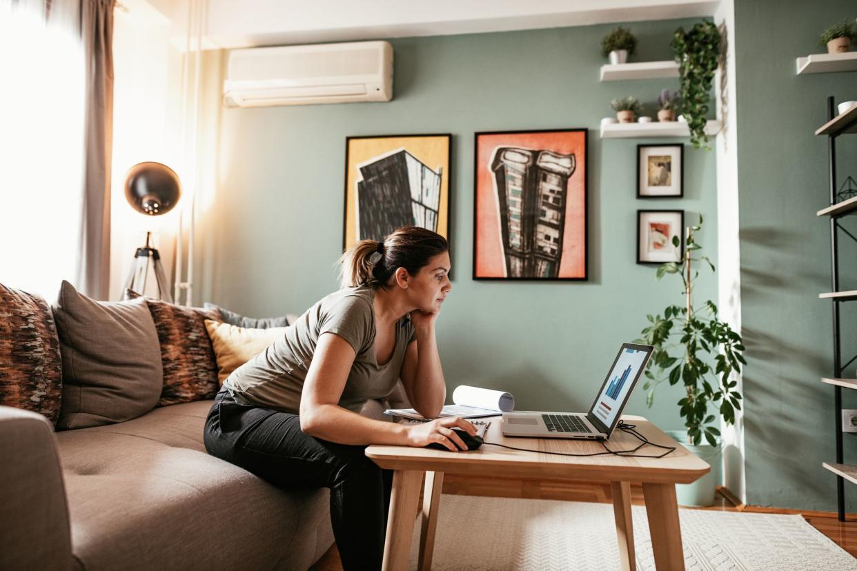 Woman working from home due to restrictive measures, lockdown and quarantine due to pandemic Coronavirus