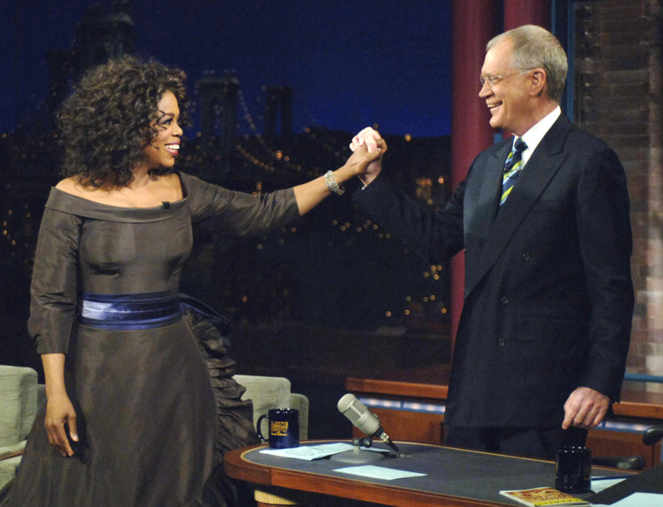 FILE - In this Dec. 1, 2005 file photo provided by CBS, Oprah Winfrey appears with David Letterman during a taping of on "The Late Show with David Letterman", in New York. Following the interview, Dave escorted Oprah across 53rd street to the opening of her new Broadway Show "The Color Purple". Letterman announced his retirement during a taping on Thursday, April 3, 2014. Although no specific date was announced he told the audience that he will leave his desk sometime in 2015. (AP Photo/Jeffrey R. Staab/CBS)