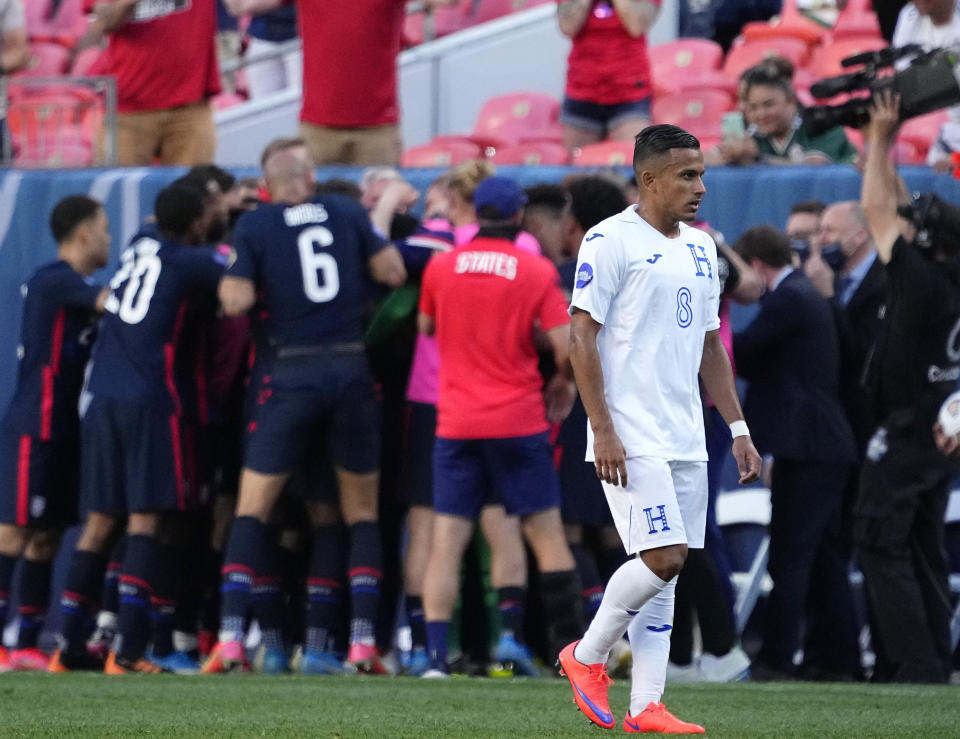 Honduras' Edwin Rodríguez (8) reacts as the U.S. team celebrates goal by Jordan Siebatcheu during the second half of a CONCACAF Nations League soccer semifinal Thursday, June 3, 2021, in Denver. (AP Photo/Jack Dempsey)