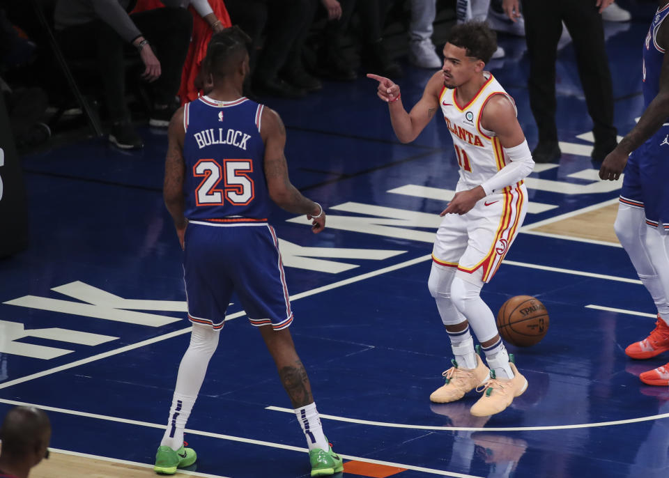 NEW YORK, NY - JUNE 02:  Trae Young #11 of the Atlanta Hawks points at Reggie Bullock #25 of the New York Knicks after scoring in the first quarter during Game Five of the Eastern Conference first round series at Madison Square Garden on June 02, 2021 in New York City. NOTE TO USER: User expressly acknowledges and agrees that, by downloading and or using this photograph, User is consenting to the terms and conditions of the Getty Images License Agreement.  (Photo by Wendell Cruz-Pool/Getty Images)