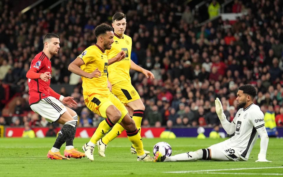 Sheffield United's Auston Trusty challenges Manchester United's Diogo Dalot during the Premier League match at Old Trafford, Manchester