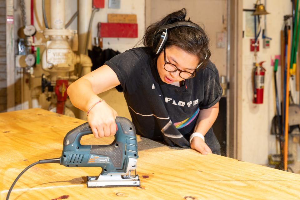 Lead carpenter Monica Tran works on set pieces for Southern Plains Productions' July 20-22 production of "The Chinese Lady."