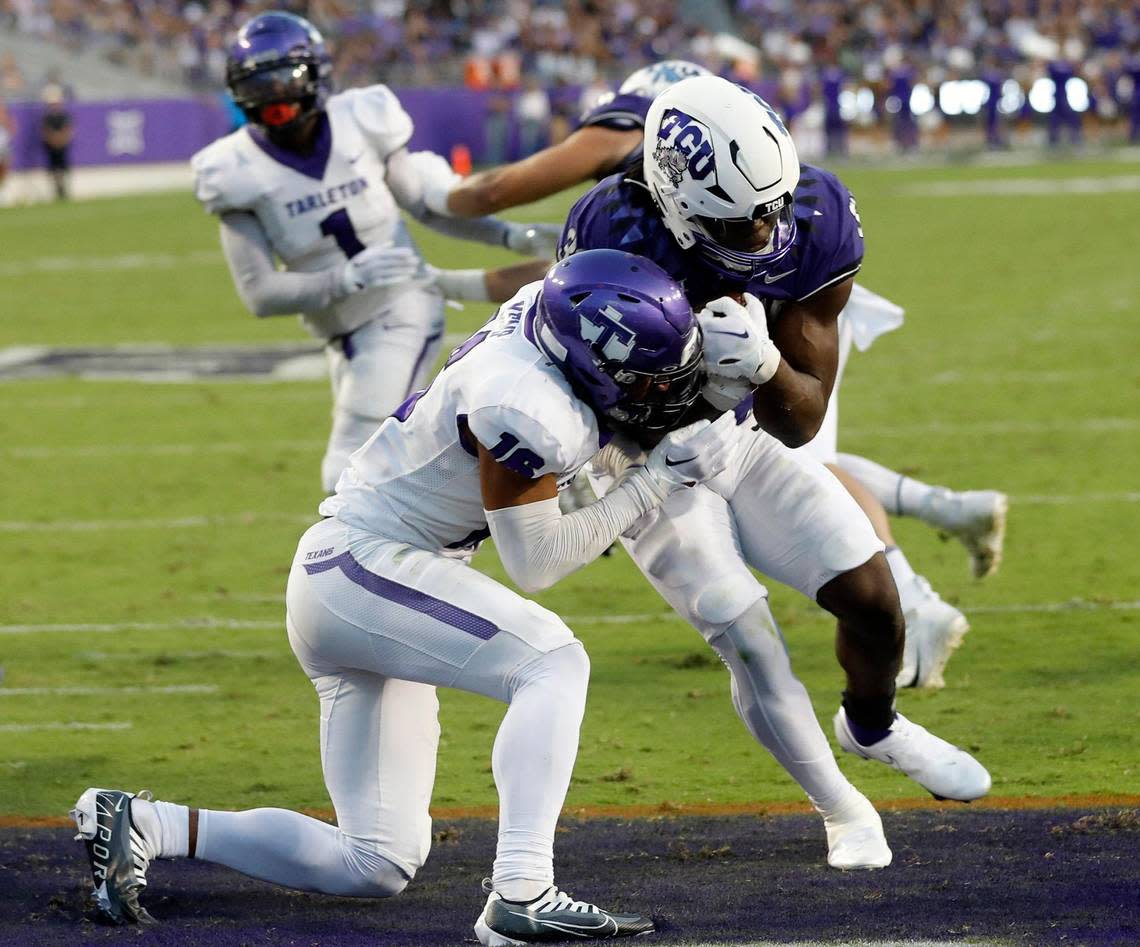 TCU running back Kendre Miller (33) breaks the tackle of Tarleton State defensive back Josh Kemp (16) at Amon G. Carter Stadium.