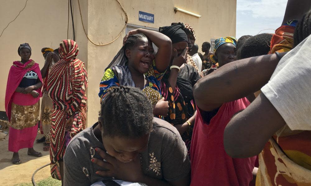 Relatives of the six aid workers who were ambushed and killed grieve outside the morgue in Juba, South Sudan