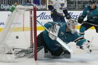 CORRECTS TO BRAYDEN SCHENN SCORED NOT PERRON - The puck crosses the net behind San Jose Sharks goaltender Devan Dubnyk on a goal scored by St. Louis Blues' Brayden Schenn (not shown) during the second period of an NHL hockey game in San Jose, Calif., Monday, March 8, 2021.(AP Photo/Jeff Chiu)