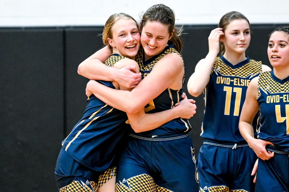 Ovid-Elsie's Braeden Tokar, left, and Ava Bates hug after their victory over Grass Lake on Tuesday, March 7, 2023, at Dansville High School.