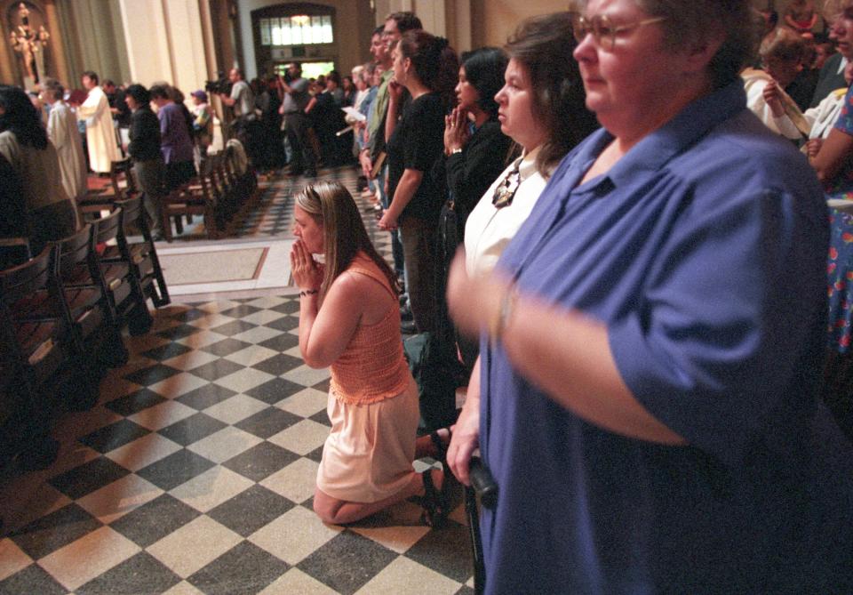 Patricia Petrowitz falls to her knees in prayer at St. James Cathedral in Seattle during a prayer service on September 11, 2001, in the aftermath of the terrorist attacks on the World Trade Center in New York City and the Pentagon. The cathedral was filled to capacity.