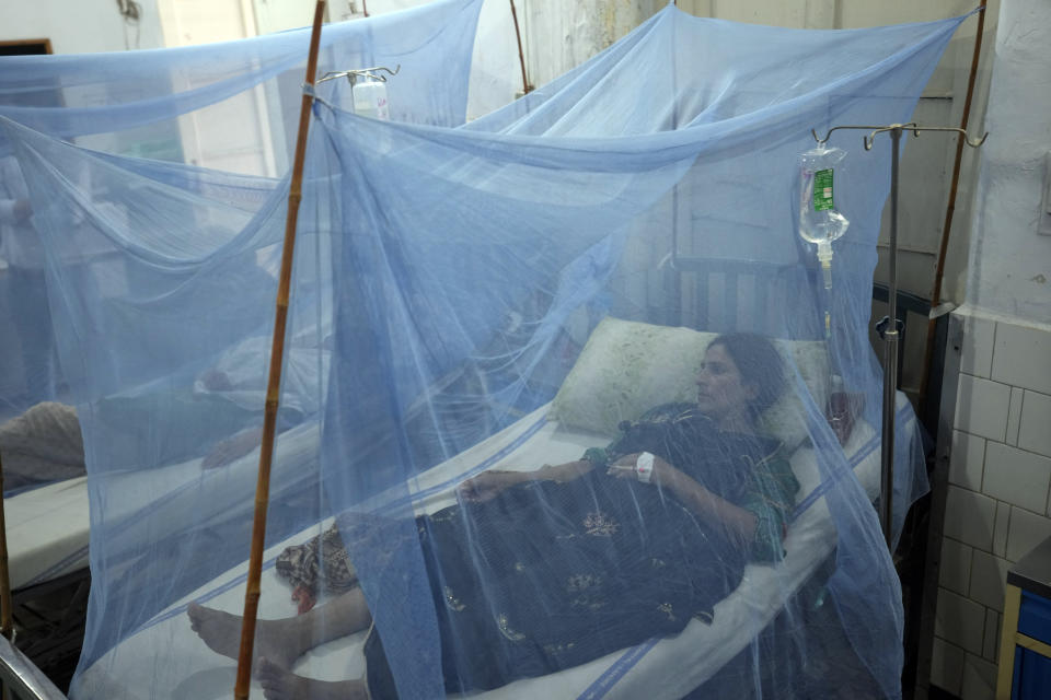 Pakistani patients suffering from dengue fever, a mosquito-borne disease, are treated in an isolation ward, at a hospital in Lahore, Pakistan, Friday, Sept. 23, 2022. Pakistan has deployed thousands of additional doctors and paramedics in the country's worst flood-hit province to contain the spread of diseases that have killed over 300 people among the flood victims, officials said Friday. (AP Photo/K.M. Chaudary)