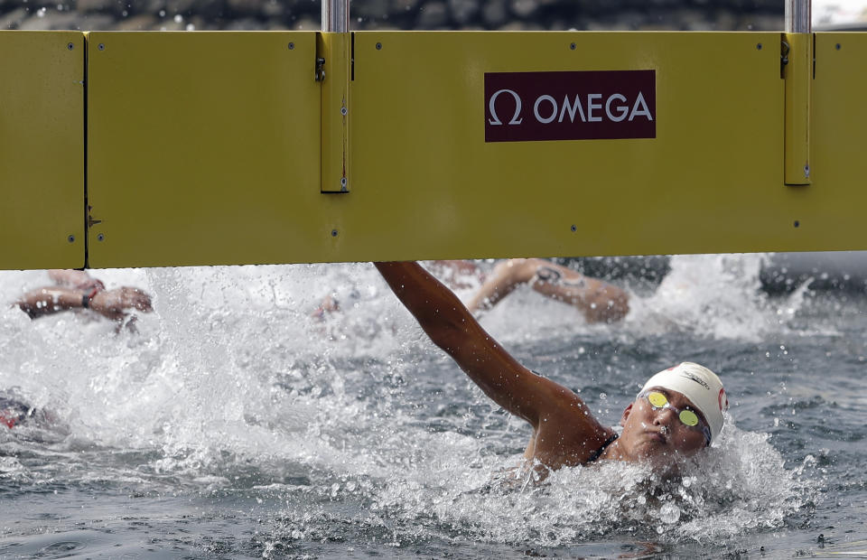 Xin Xin of China touches the timing board to win the women's 10km open water swim at the World Swimming Championships in Yeosu, South Korea, Sunday, July 14, 2019. (AP Photo/Mark Schiefelbein)