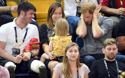 Prince Harry with British Paralympian Dave Henson, his wife Hayley Henson and their two-year-old daughter Emily  - Credit: Karwai Tang/WireImage