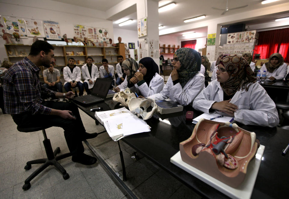 In this Wednesday, April 9, 2014 photo, Palestinian students attend a class in the Faculty of Medicine at the Al-Quds University in the West Bank village of Abu Dis, near Jerusalem. Dozens of Palestinian doctors who graduated from Al Quds University, a school that has a foothold in east Jerusalem, are caught in the political battle between Israel and the Palestinians over the city’s eastern sector. Israel has refused to recognize the university’s graduates -- a move that could amount to acknowledging the Palestinian claims to east Jerusalem as their capital. (AP Photo/Majdi Mohammed)