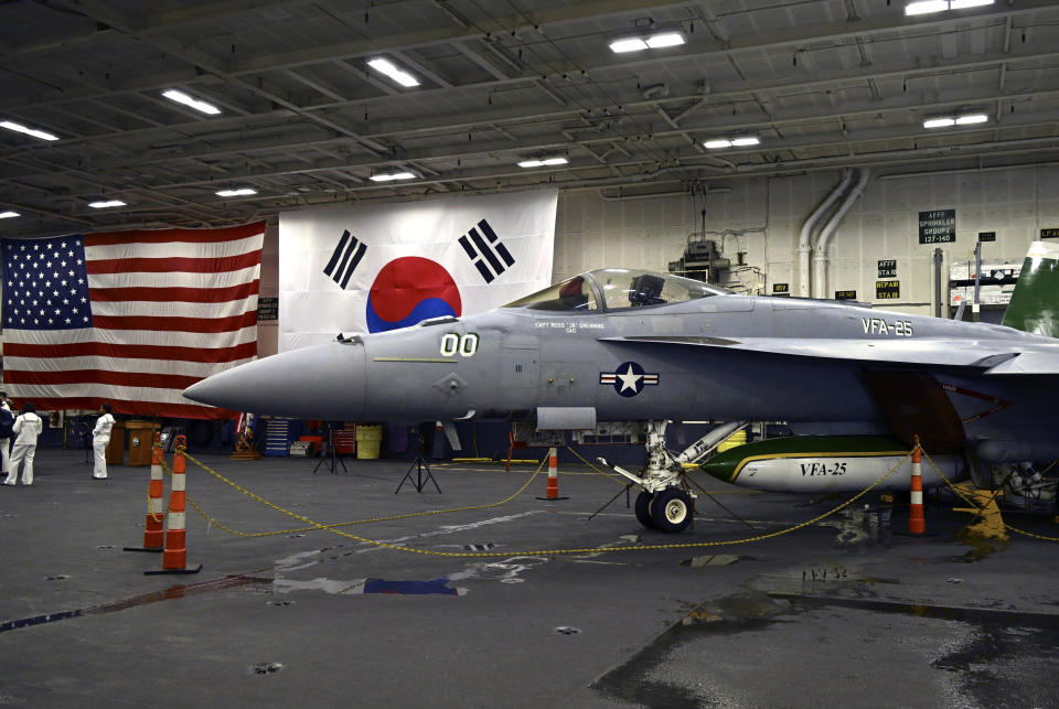 FILE - An F-18 fighter aircraft sits in the hanger of the Theodore Roosevelt (CVN 71), a nuclear-powered aircraft carrier, anchored in Busan Naval Base in Busan, South Korea Saturday, June 22, 2024. The newly-inaugurated Freedom Edge exercise is wrapping up in the East China Sea, having brought together Japanese, South Korean and American naval assets for multi-domain maneuvers for the first time.(Song Kyung-Seok/Pool Photo via AP, File)