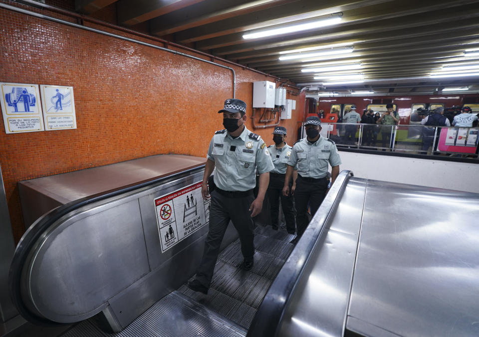 Members of the Mexican National Guard patrol inside a city's subway station in Mexico City, Thursday, Jan. 12, 2023. The mayor of Mexico City says that more the 6 thousand National Guard officers will be posted in the city's subway system after a series of accidents that officials say could be due to sabotage. (AP Photo/Fernando Llano)