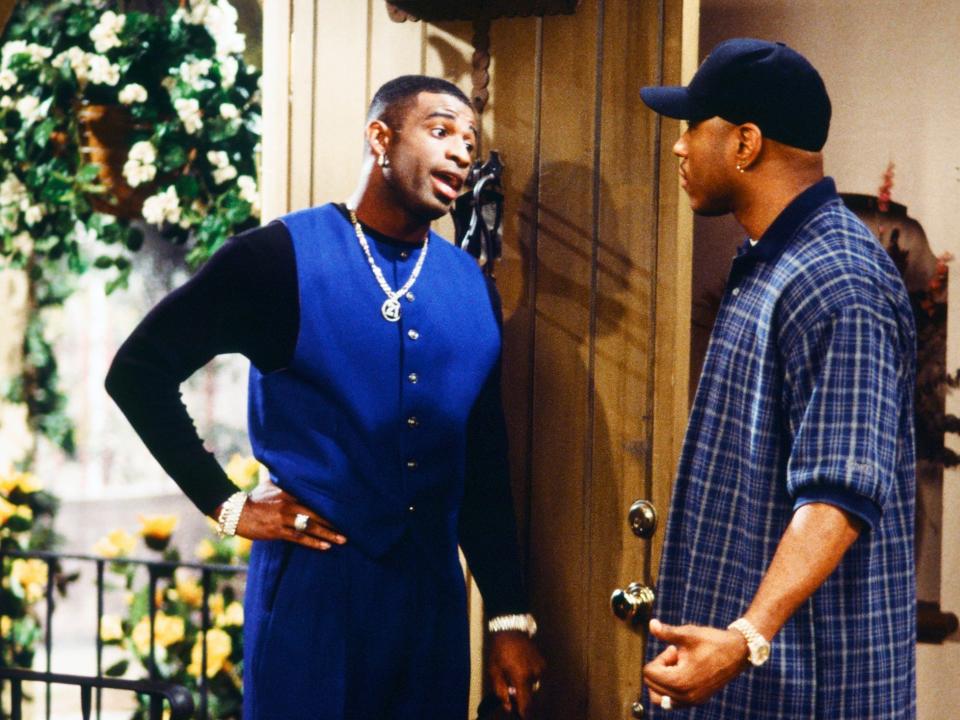 Deion Sanders appears on an episode of "In the House" alongside LL Cool J (right).