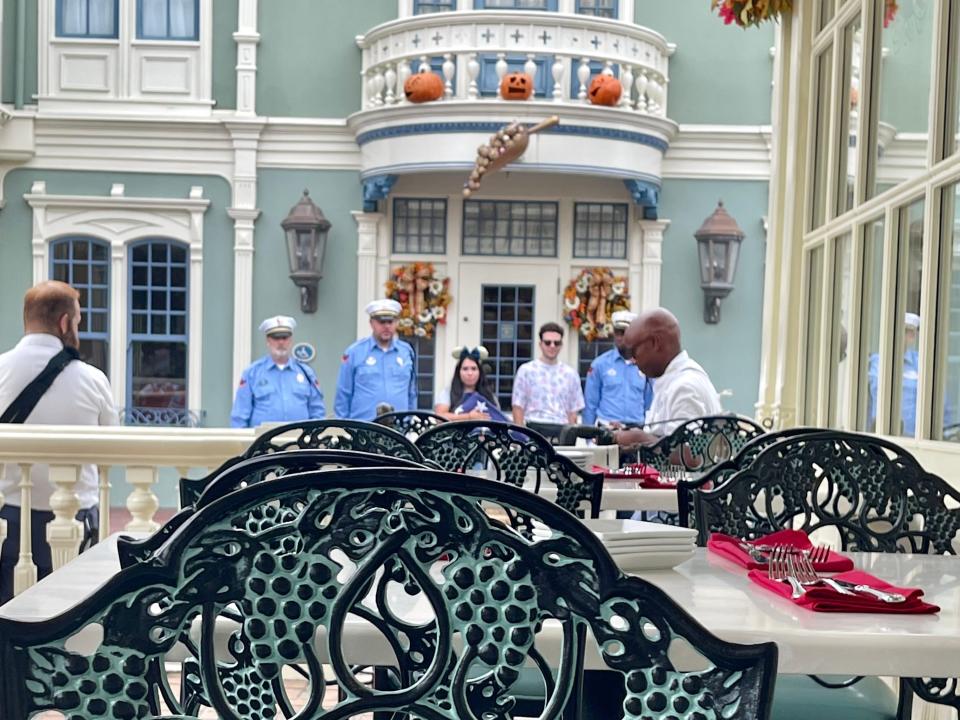 view of the flag ceremony at magic kingdom from the patio at tony's town square restaurant at disney world