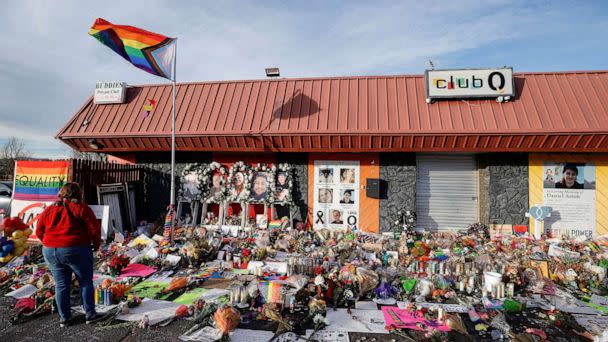 PHOTO: A person looks on at the flowers and mementos left at a memorial at Club Q after a mass shooting at the LGBTQ nightclub in Colorado Springs, Colorado, Nov. 26, 2022. (Isaiah Downing/Reuters)