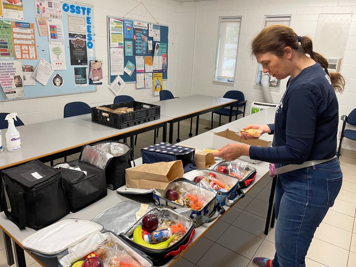 Sandra Copeland of the breakfast program at Carson Grove Elementary School in Ottawa helps prepare food for students. She says she's had to get creative to stretch her budget as prices rise. (Kristen Everson/CBC - image credit)