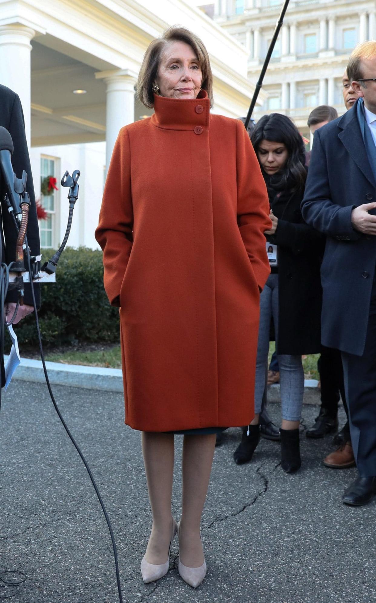 Nancy Pelosi wears a red Max Mara coat for a meeting at the White House last month.  - REUTERS