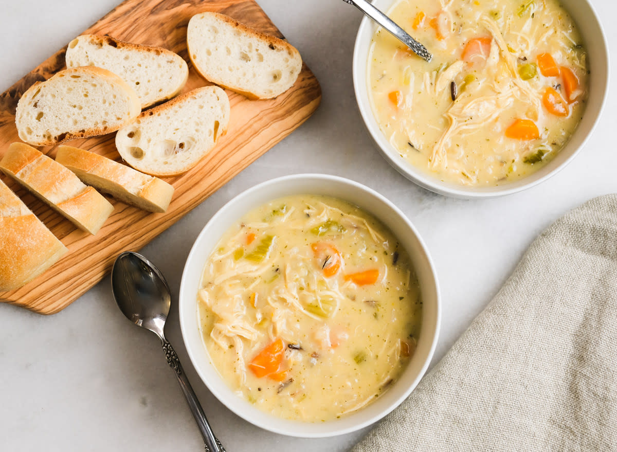 two bowls of instant pot chicken and rice soup with bread