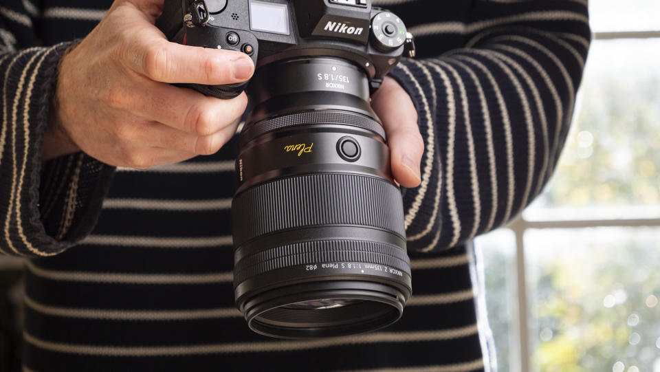 Nikon Z 135mm f/1.8 S Plena lens in the hand