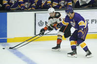 Anaheim Ducks center Troy Terry (61) and Los Angeles Kings center Anze Kopitar (11) reach for the puck during the second period of an NHL hockey game Tuesday, Feb. 2, 2021, in Los Angeles. (AP Photo/Ashley Landis)