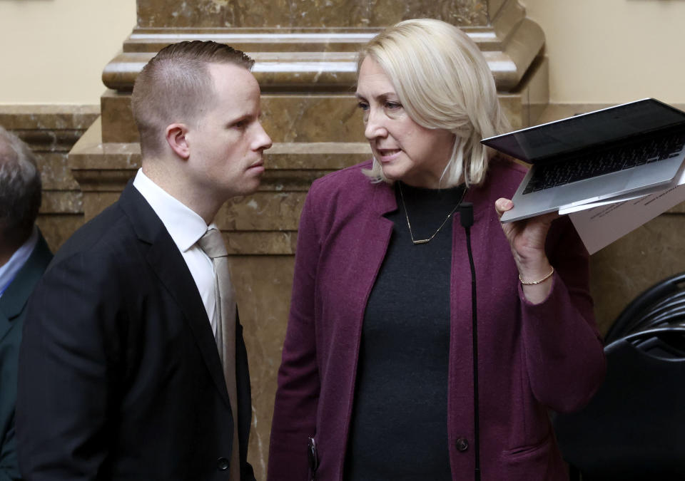 FILE - State Reps. Trevor Lee and Karianne Lisonbee speak before the start of the session at the Capitol in Salt Lake City, Friday, Jan. 26, 2024. Utah's legislature became the latest in the U.S. to pass a bill Friday prohibiting diversity training, hiring and inclusion programs at universities and in state government. (Laura Seitz/The Deseret News via AP, File)