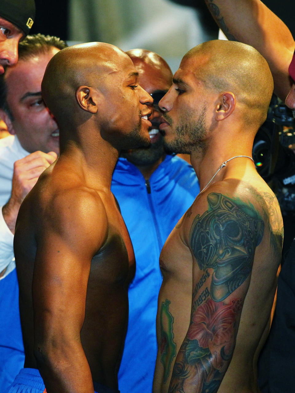 LAS VEGAS, NV - MAY 04: WBA super welterweight champion Miguel Cotto (R) and Floyd Mayweather Jr. face off during the official weigh-in for their bout at the MGM Grand Garden Arena on May 4, 2012 in Las Vegas, Nevada. Cotto will defend his title against Mayweather on May 5, 2012 in Las Vegas. (Photo by Al Bello/Getty Images)