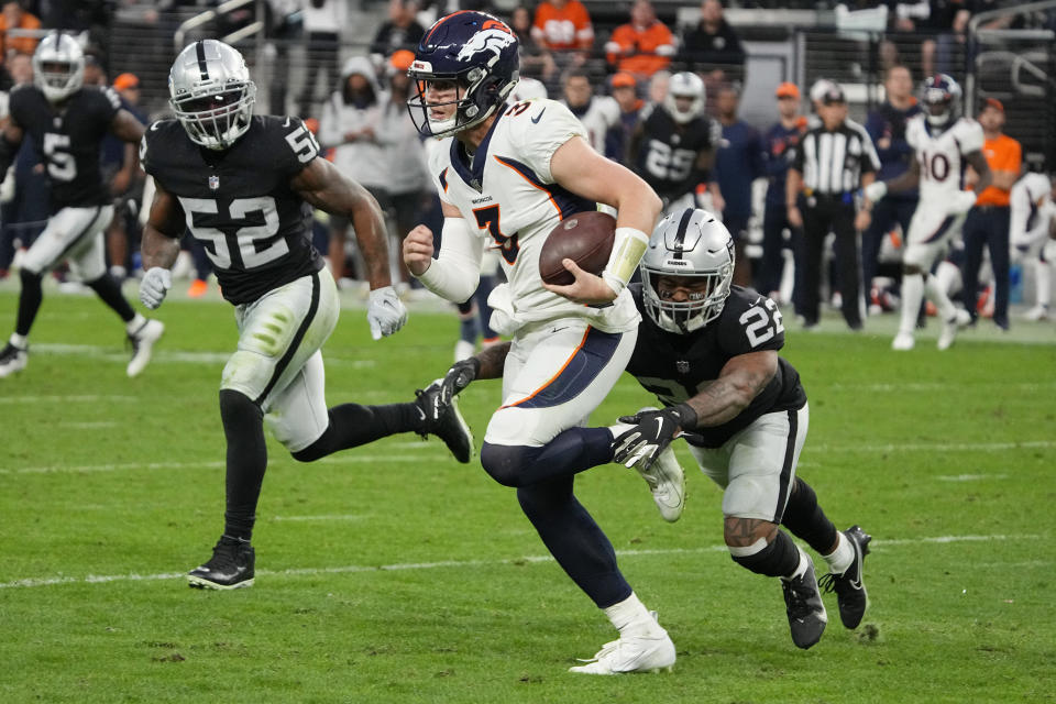 Las Vegas Raiders defensive back Keisean Nixon (22) tackles Denver Broncos quarterback Drew Lock (3) during the second half of an NFL football game, Sunday, Dec. 26, 2021, in Las Vegas. (AP Photo/Rick Scuteri)