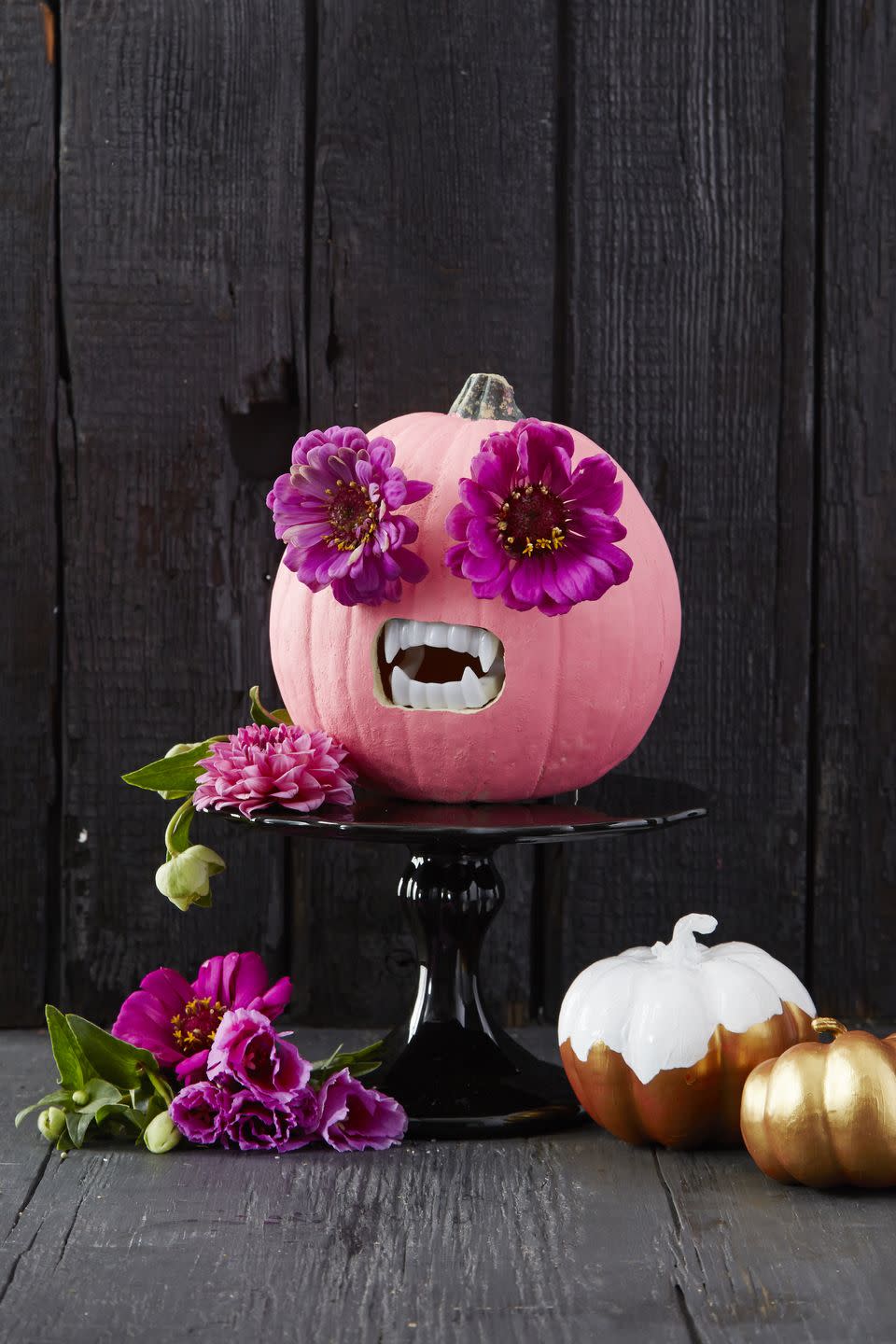 <p>After painting your pumpkin to your liking, use an awl to create eyeholes. You can place flowers, or leave as is, to serve as the eyes. To finish, carve a square for fake fangs.</p><p><a class="link " href="https://www.amazon.com/Vampire-Plastic-Costume-Accessory-Favors/dp/B003O6F9RQ?tag=syn-yahoo-20&ascsubtag=%5Bartid%7C10055.g.23570028%5Bsrc%7Cyahoo-us" rel="nofollow noopener" target="_blank" data-ylk="slk:SHOP FANGS;elm:context_link;itc:0;sec:content-canvas">SHOP FANGS</a></p>