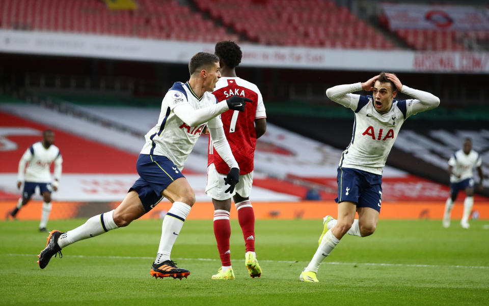 <p>LONDON, ENGLAND - MARCH 14: Erik Lamela of Tottenham Hotspur celebrates with team mate Sergio Reguilon (R) after scoring their side's first goal during the Premier League match between Arsenal and Tottenham Hotspur at Emirates Stadium on March 14, 2021 in London, England. Sporting stadiums around the UK remain under strict restrictions due to the Coronavirus Pandemic as Government social distancing laws prohibit fans inside venues resulting in games being played behind closed doors. (Photo by Tottenham Hotspur FC/Tottenham Hotspur FC via Getty Images)</p>
