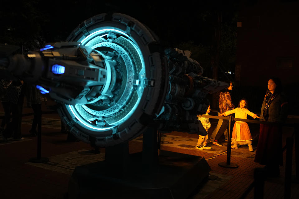 A child reacts to a depiction of a space craft at an exhibition about "The Three-Body Problem" in Chengdu, Sichuan province on Friday, Oct. 20, 2023. The series that began with "The Three-Body Problem," written by former engineer Liu Cixin, helped Chinese science fiction break through internationally, winning awards and making it onto the reading lists of the likes of former U.S. President Barack Obama and Mark Zuckerberg. (AP Photo/Ng Han Guan)