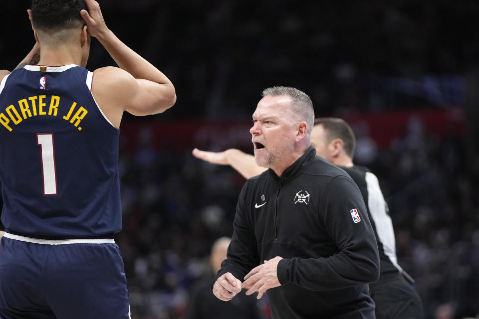 Denver Nuggets coach Michael Malone, right, yells at referees as he receives a technical foul while Denver Nuggets forward Michael Porter Jr. reacts during the second half of an NBA basketball game against the Los Angeles Clippers Thursday, April 4, 2024, in Los Angeles. (AP Photo/Mark J. Terrill)