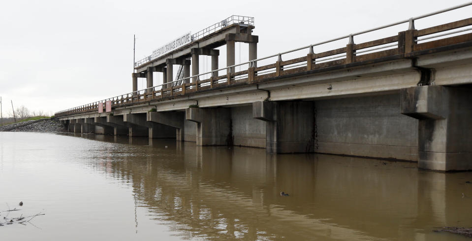 Water from recent rainfalls pool up along the Steele Bayou Drainage Structure on a levee in Warren County, Miss., as shown in this Friday, March 1, 2019 photograph. As Mississippi River backwaters in the Eagle Lake area are at flood level and are projected to rise even higher, it is causing limited access to residents by emergency vehicles. The levee protects thousands of square miles of the Delta region from even worse flooding by the Mississippi River. (AP Photo/Rogelio V. Solis)