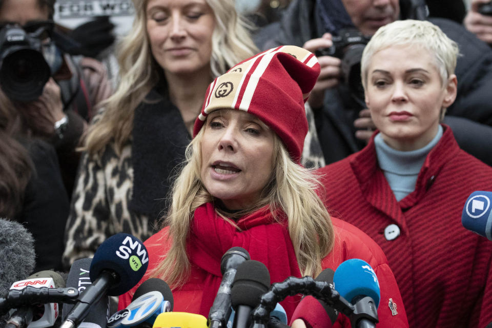 Actor Rosanna Arquette speaks as actor Rose McGowan, right, listens at a news conference outside a Manhattan courthouse after the arrival of Harvey Weinstein, Monday, Jan. 6, 2020, in New York. Weinstein is on trial on charges of rape and sexual assault, more than two years after a torrent of women began accusing him of misconduct. (AP Photo/Mark Lennihan)