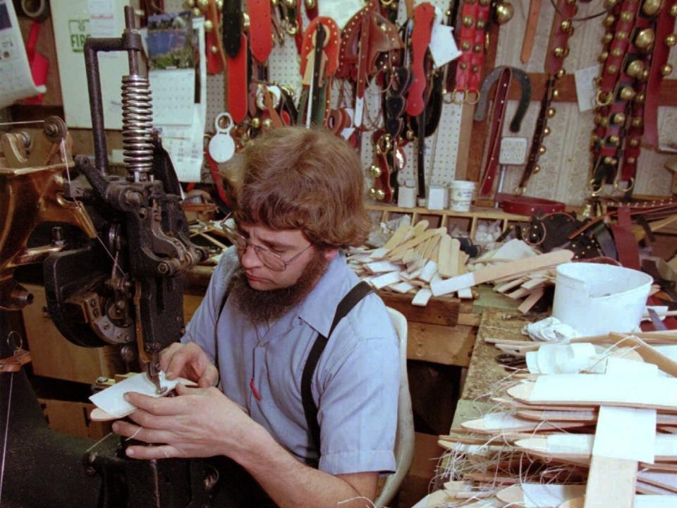 John Stoltzfus works sewing harnesses at Smucker's Harness Shop in Narvon, Pa. Tuesday, March 3, 1998.