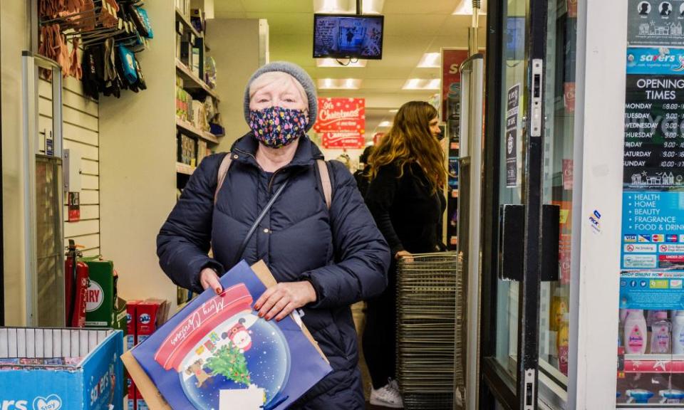 A woman wears a mask while Christmas shopping.