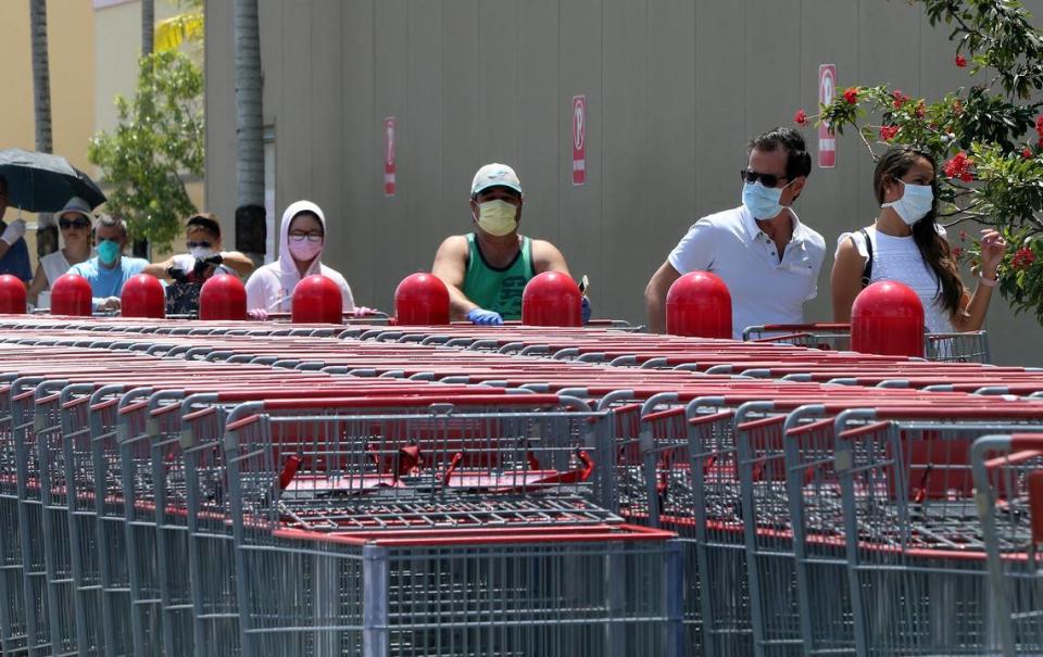 Due to the coronavirus COVID-19 pandemic, customers lined up wearing protective masks for protection to enter the Costco store located at Flagler Street and SW 79th Ave. in Miami, on Friday, April 3, 2020.