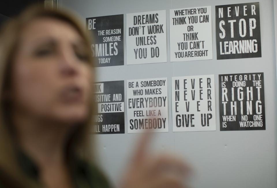 Signs with affirming words hang on the wall at the counseling and wellness center