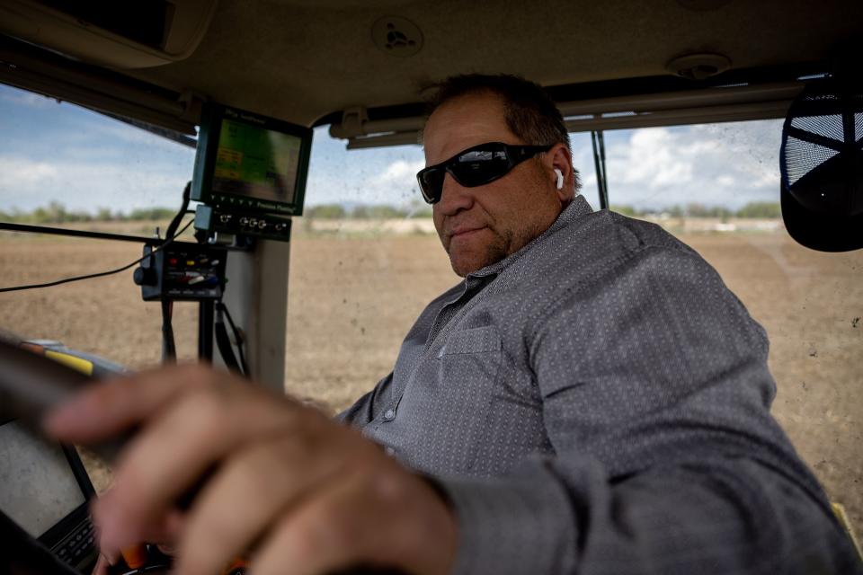 Ron Gibson, owner of Gibson’s Green Acres and president of the Utah Farm Bureau, pilots his tractor while planting corn on his farm in Ogden on Thursday, May 4, 2023. | Spenser Heaps, Deseret News