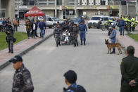 Former rebel leader Seuxis Hernandez leaves La Picota jail escorted by prison guards in Bogota, Colombia, Friday, May 17, 2019. The former peace negotiator, best known by his alias Jesús Santrich, was re-arrested immediately after his release that was orderer by a special tribunal investigating war crimes during Colombia's civil conflict that ruled Wednesday that he should not be extradited to the United States. (AP Photo/Fernando Vergara)