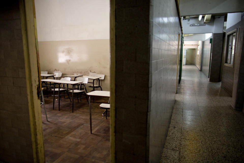 Desks sit empty and hallways are clear of students at a public school in a Buenos Aires suburb, Argentina, Wednesday, March 19, 2014. Striking teachers in the Buenos Aires province are demanding a wage increase higher than what is currently being offered by the provincial administration. The strike is in its 11th day, affecting more than 3 million students. (AP Photo/Natacha Pisarenko)