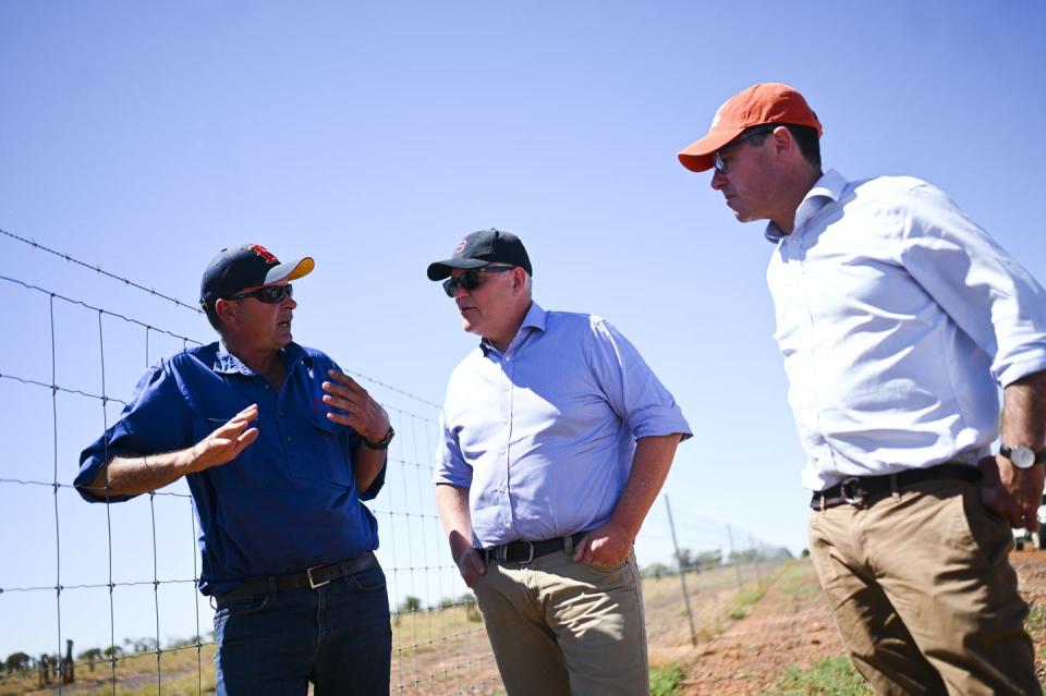 <span class="caption">The government says landholders should be rewarded for boosting biodiversity. Pictured: Prime Minister Scott Morrison and Agriculture Minister David Littleproud speak to a farmer.</span> <span class="attribution"><span class="source">Lukas Coch/AAP</span></span>