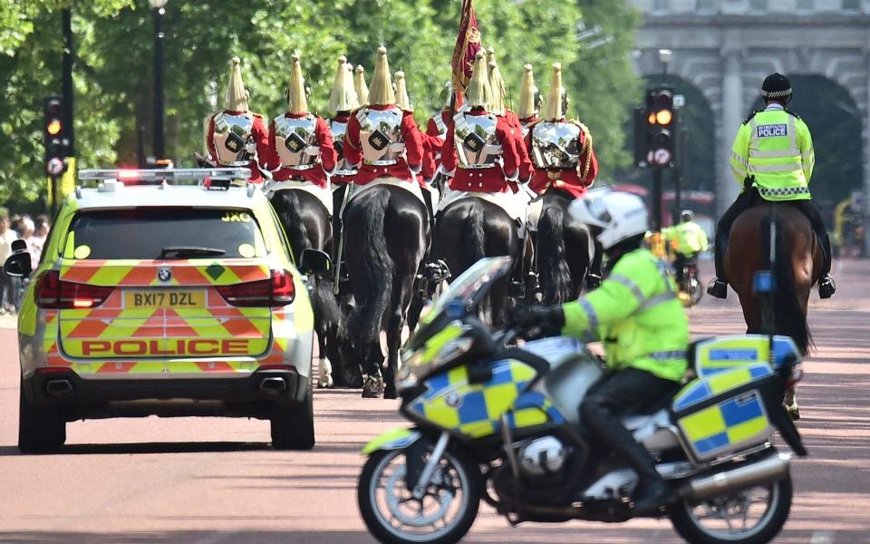 Police escort members of the Household Cavalry along The Mall on Wednesday morning as security is stepped up across the capital - Credit: Dominic Lipinski/PA