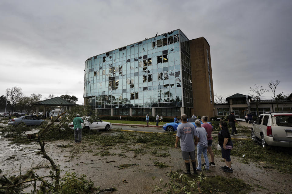People survey damage following a tornado at the Iberia Medical Center, Wednesday, Dec. 14, 2022, in New Iberia, La. (Leslie Westbrook/The Times-Picayune/The New Orleans Advocate via AP)