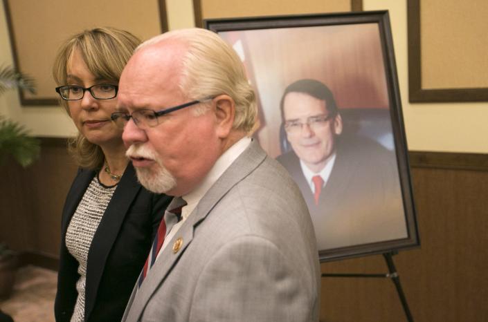 Former U.S. Rep. Gabrielle Giffords talks with then-Rep. Ron Barber before the dedication of the John M. Roll U.S. Courthouse in Yuma on April 24, 2014.
